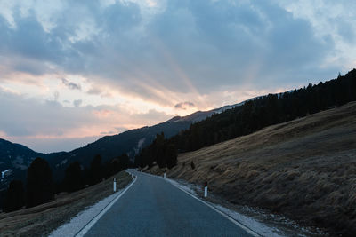 Road amidst landscape against sky during sunset