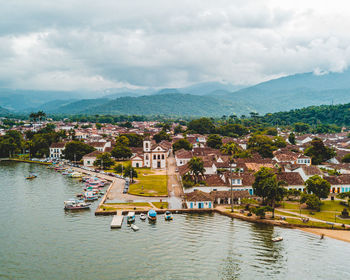 High angle view of townscape by mountains against sky