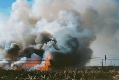 Panoramic shot of bonfire on field against sky