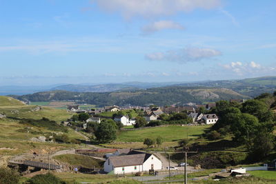 Scenic view of landscape and houses against sky