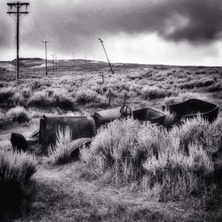 Scenic view of grassy field against cloudy sky