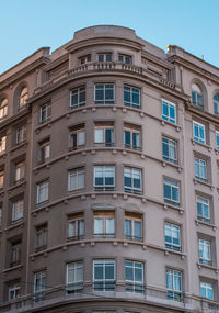 Low angle view of apartment building against blue sky