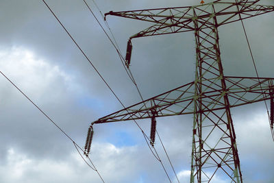 Low angle view of electricity pylon against sky