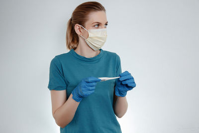 Portrait of a young woman wearing mask