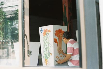 Woman sitting by window