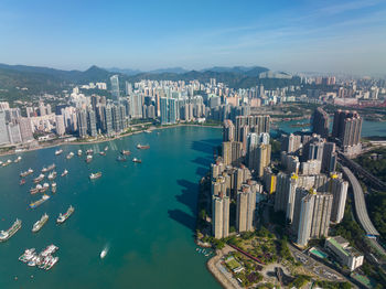 High angle view of townscape by sea against sky