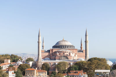 View of buildings in city against clear sky