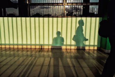 Shadow of people walking on floor