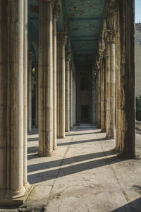 Entrance of historic building, with pillars left and right. an old abandoned sovjet building light