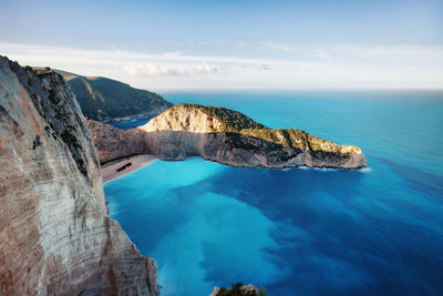 Scenic view of sea and rock formation against sky