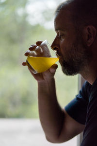Man drinking from a glass with the dissolved vitamins