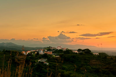 Scenic view of landscape against orange sky
