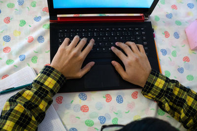 High angle view of person using laptop on table