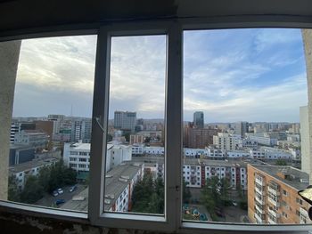 High angle view of buildings seen through glass window