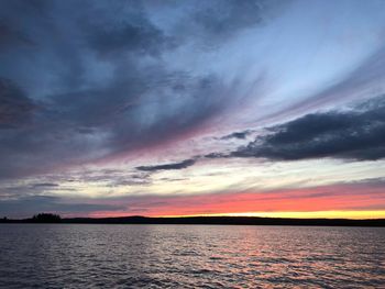 Scenic view of sea against dramatic sky during sunset