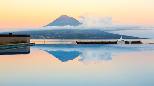 Scenic view of swimming pool against sky during sunset