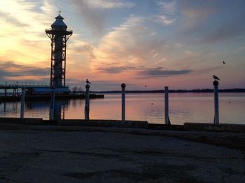 Silhouette of lighthouse at seaside