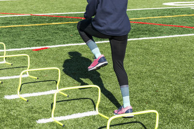 Low section of man skateboarding on grass