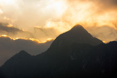 Scenic view of silhouette mountains against sky during sunset