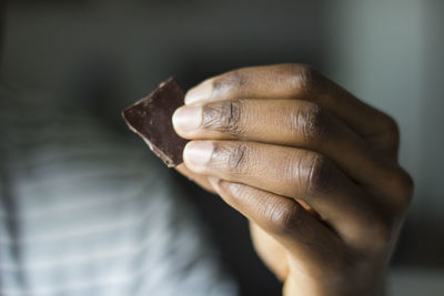 Cropped hand holding chocolate