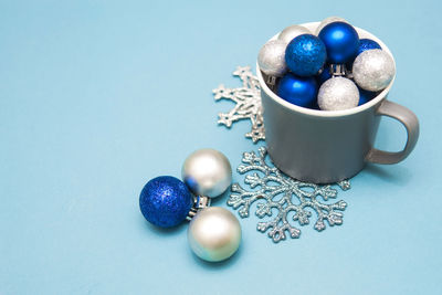 High angle view of coffee with blue balls on table
