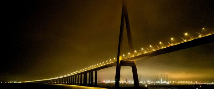 Low angle view of suspension bridge at night