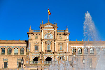 Low angle view of building against blue sky