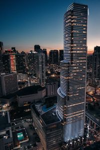 Aerial view of illuminated cityscape against clear sky