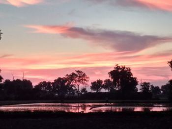 Scenic view of lake against orange sky