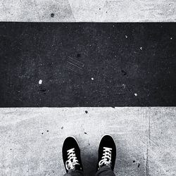 Low section of man standing on street