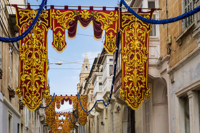 Low angle view of decorations hanging on building