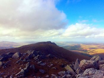 Scenic view of mountains against cloudy sky