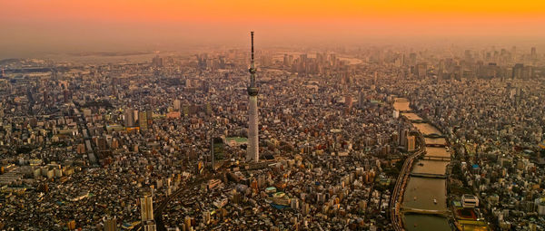 Tokyo, japan modern urban skyline with sunset overlooking the tower.