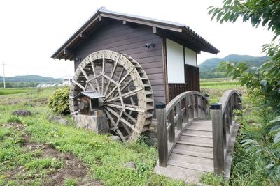 Built structure on field against sky