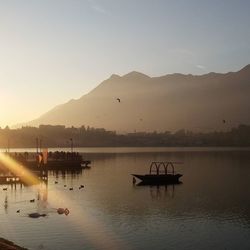 Boats in lake at sunset