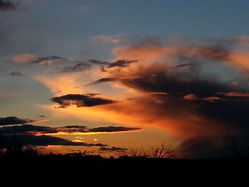 Scenic view of landscape against sky at sunset