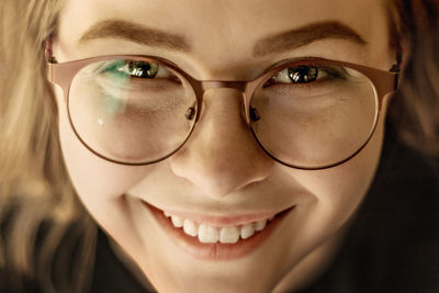 Close-up portrait of smiling young woman