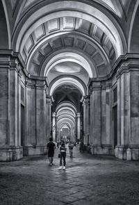 People walking in corridor of building