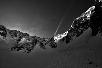 Scenic view of snow covered mountains against sky