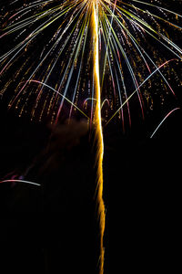 Low angle view of firework display at night