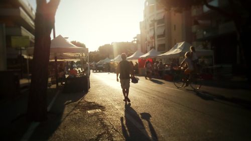 People on street in city at sunset
