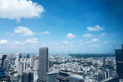 High angle view of modern buildings in city against sky