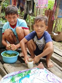 Portrait of cute boy preparing food outdoors