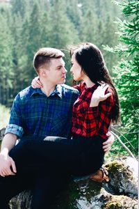 Loving young couple romancing in forest