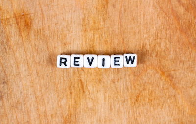 Directly above shot of text written on wooden surface