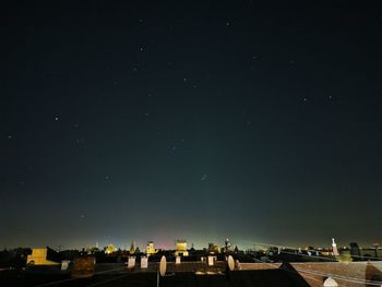 Buildings in city against sky at night