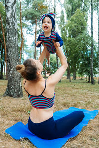 Mom and baby yoga outdoor classes. wellness, family yoga class, practicing mindfulness and