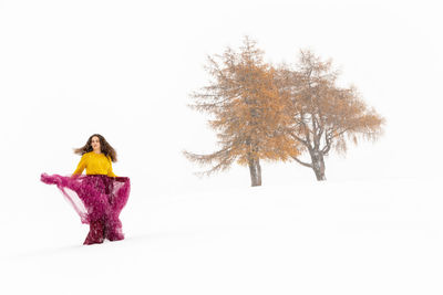 Woman standing on snow covered land