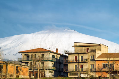 Buildings in town against blue sky