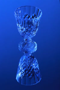 Close-up of glass bottle against blue background